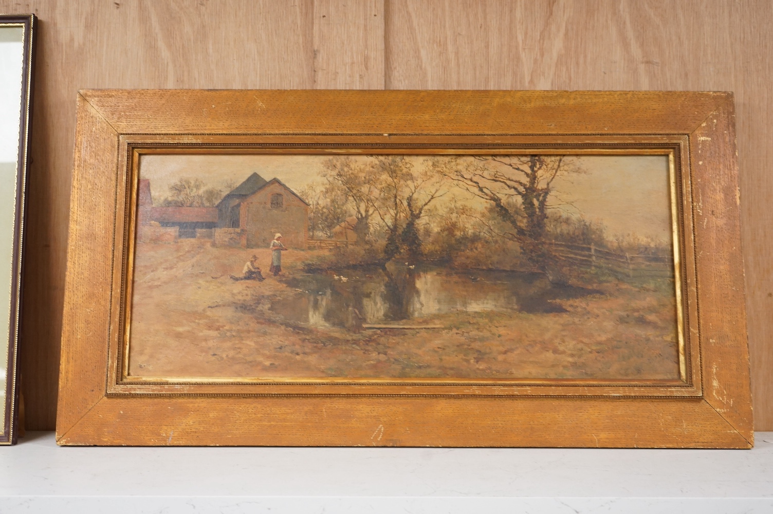 L. Watts, 19th/20th century, oil on canvas, rural scene with figures and a pond, 24 x 56cm. Condition - fair/good